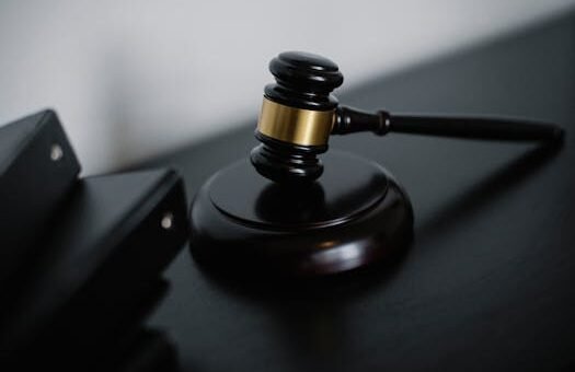 Close-up of a wooden gavel on a desk, symbolizing justice and legal authority.